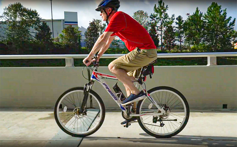 A cyclist riding along a multi-use path